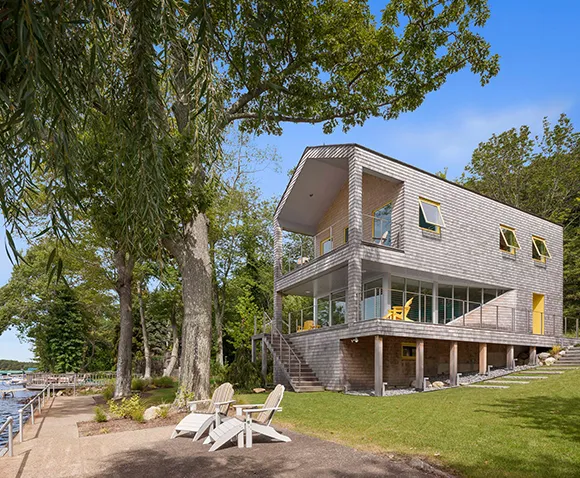 Custom lake house builders design a rustic yet elegant home with natural wood accents.